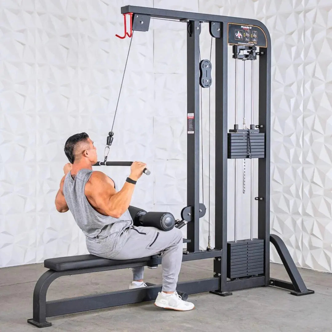 Man performing lat pulldown on a black selectorized cable machine with dual weight stacks and adjustable seat. Red safety hook visible on upper frame.