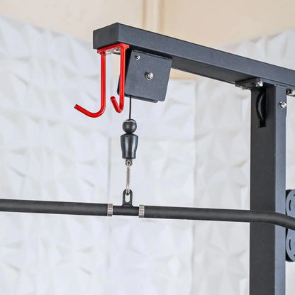 Red J-hook pulley attachment mounted on black power rack frame with chain and black ball handle for cable machine exercises.