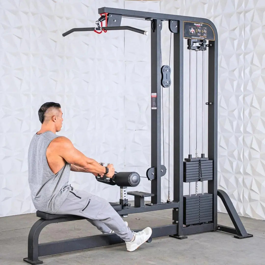 Man performing a lat pulldown exercise on a black selectorized cable machine with dual weight stacks and instruction placard mounted on the right side.