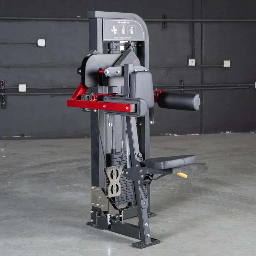 Commercial selectorized lateral raise machine with gray frame, red lever arms, and black footplate in a gym setting. Digital display panel at top shows exercise instructions.
