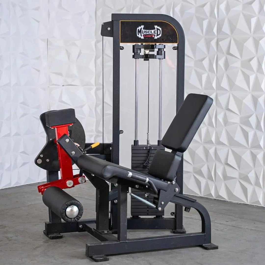 Black and red selectorized leg extension machine with padded seat and backrest, cable-driven resistance system, and Muscle D Fitness branding on the frame.