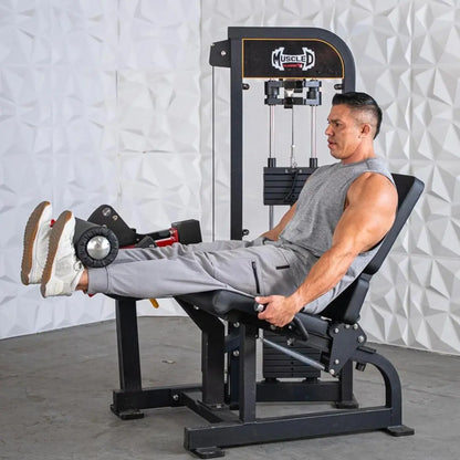 Man performing a leg extension exercise on a black Muscle D selectorized leg extension machine with weight stack, against a white textured wall.