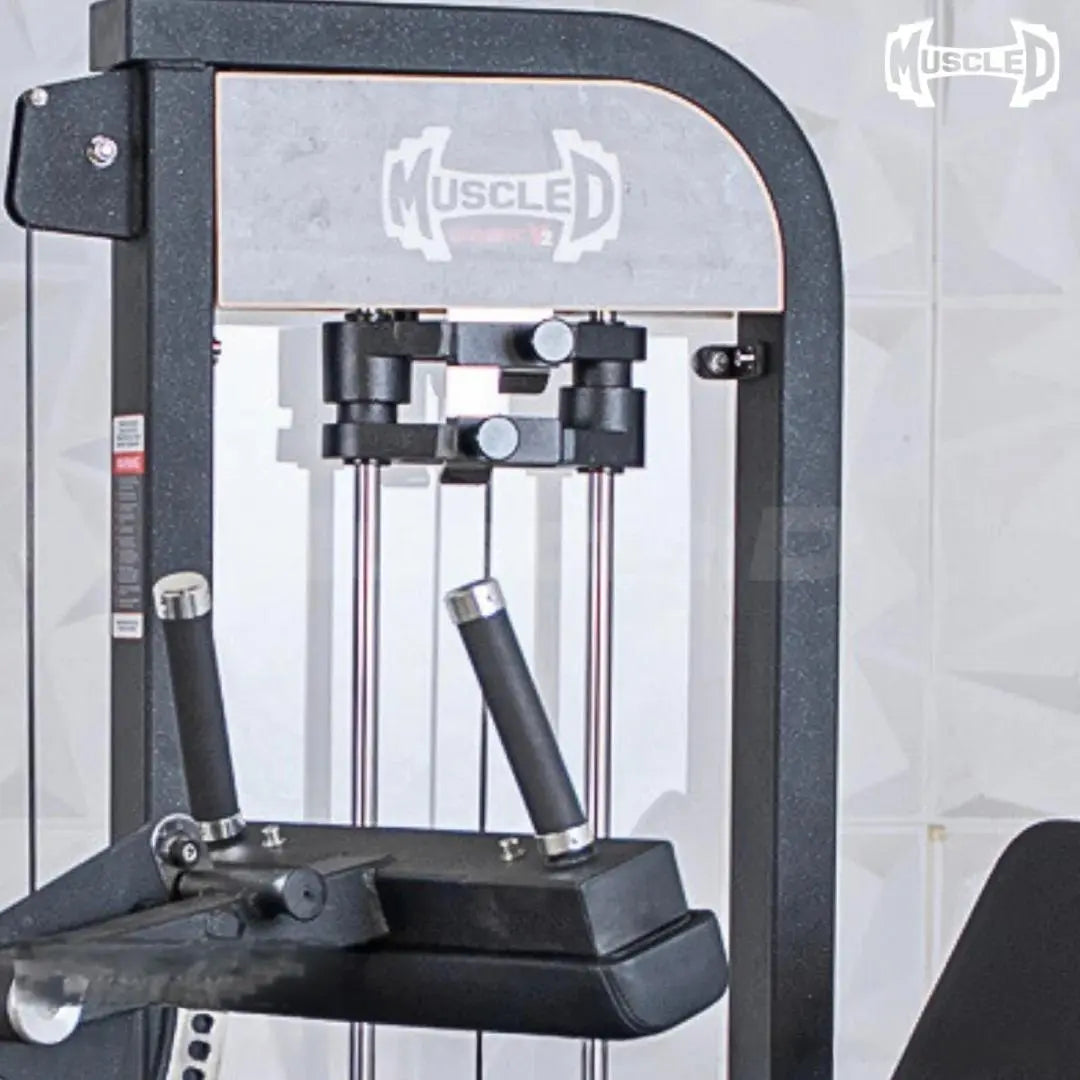 Black and white commercial leg extension and seated leg curl combo machine with dual black padded foot bars, metal frame, and control lever on the side.