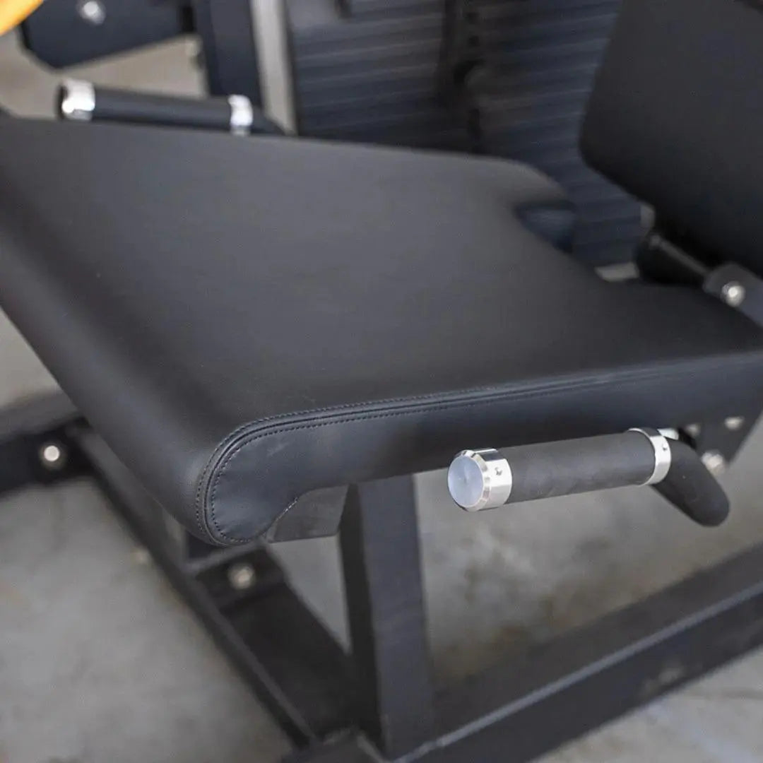 Black padded seat and leg extension/curl combo machine with chrome handle and adjustment knob visible on the side.