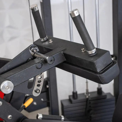 Close-up of a leg extension and leg curl combo machine showing black padded seat, textured black frame, chrome-trimmed black handles, and adjustment mechanisms on a white gym background.