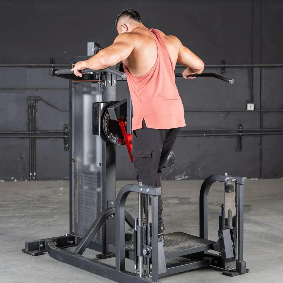 Man performing a hip abduction exercise on a selectorized multi-hip machine with black frame and red weight stack, in a gym setting.