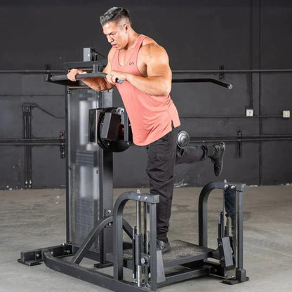 Man performing a glute exercise on a black selectorized multi-hip machine with foot platform and weight stack in a gym setting.