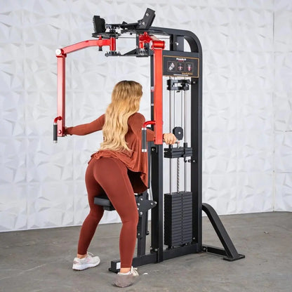 Woman performing a chest fly exercise on a red and black selectorized pec and rear delt combo machine with weight stack and control panel.