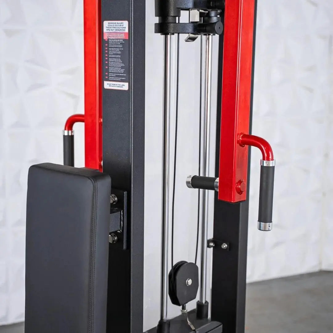 Red and black selectorized pec and rear delt combo machine with padded seat, dual handles with black grips, and chrome guide rods on a white brick background.