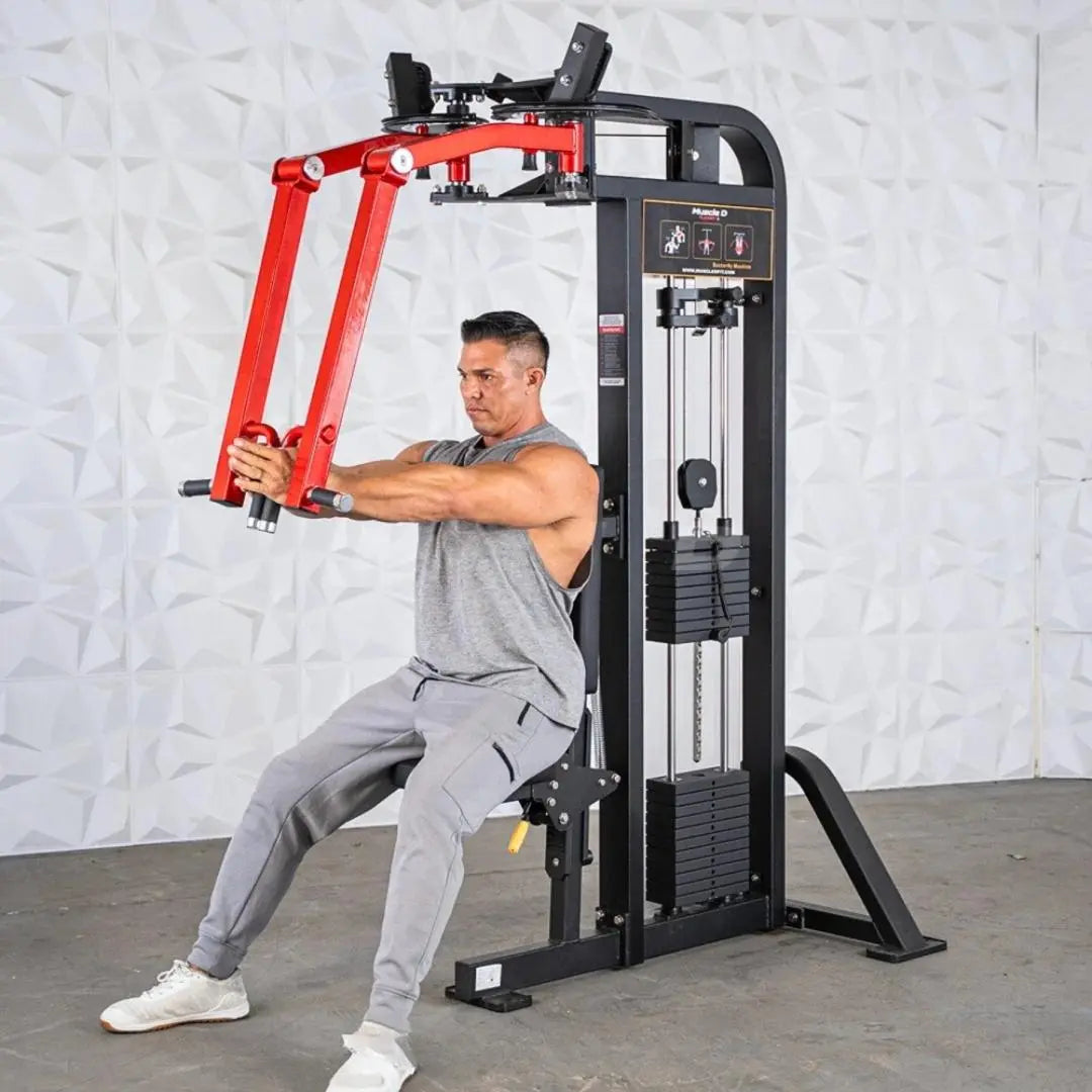 Man performing a chest press exercise on a black and red selectorized pec and rear delt combo machine with weight stack in a gym setting.