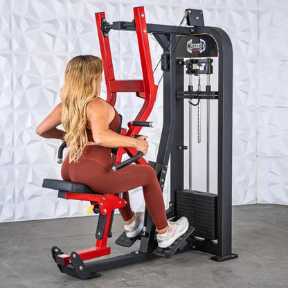 Woman performing a seated row on a black and red selectorized row machine with cable and pulley system in a studio setting.