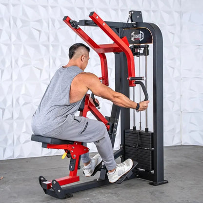 Man performing seated row on a commercial selectorized machine with red and black frame and weight stack on white textured wall background.