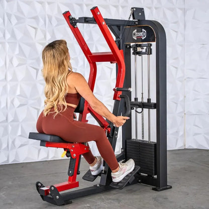 Woman performing seated row on a Muscle D Fitness selectorized machine with red frame and black base, against a white textured wall.