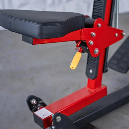 Red and black seated row machine with black padded seat, red frame with chrome bolts, yellow handle grip, and foot platform. Machine shown from side angle in gym setting.