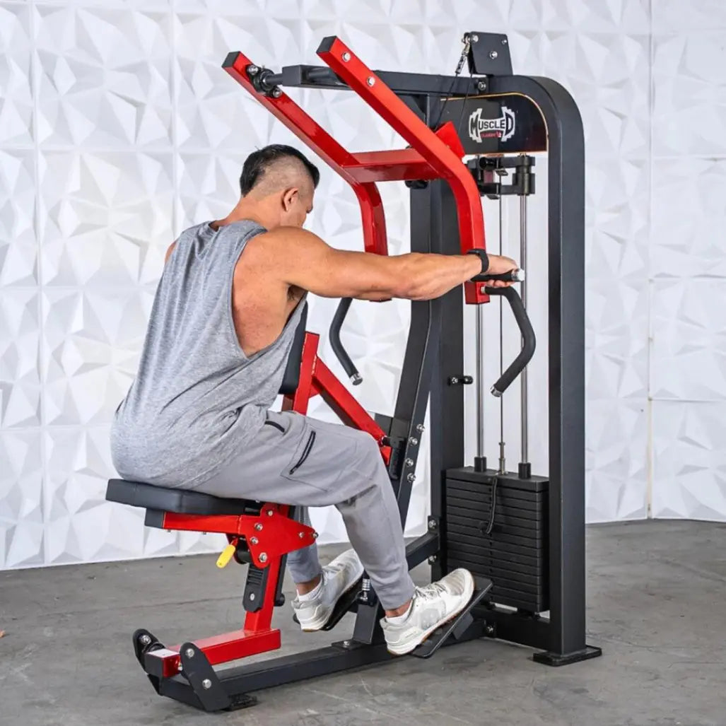 Man performing seated row on a black and red selectorized machine with weight stack, against a white textured wall.
