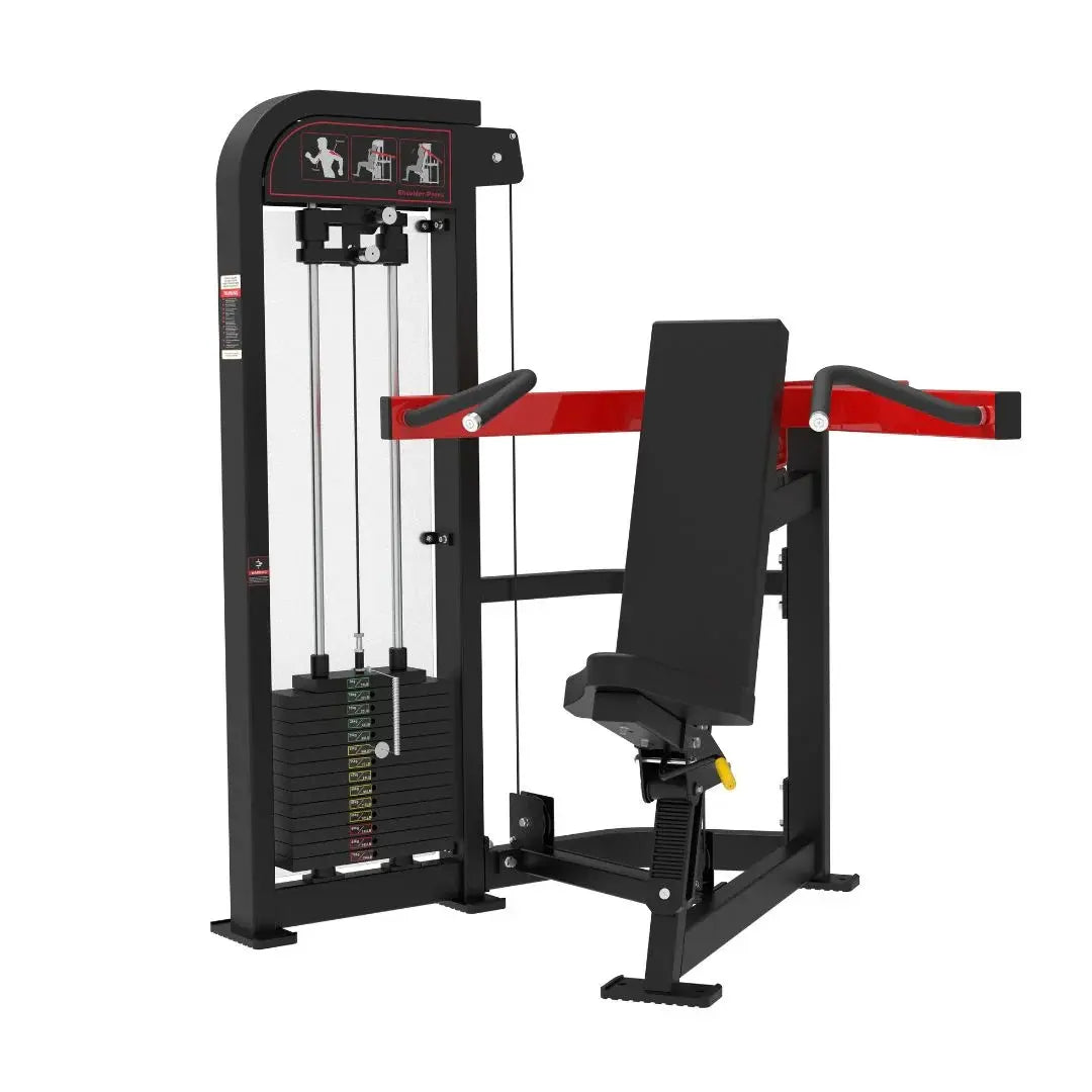 Black commercial shoulder press machine with red accents, black padded seat and backrest, weight stack on left side with cable system, and instruction placards on top frame.