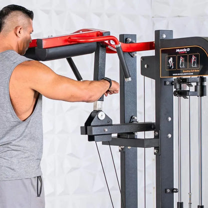 Man performing standing calf raise on a selectorized machine with red handles, black frame, and instruction placard showing exercise form against a white brick wall.