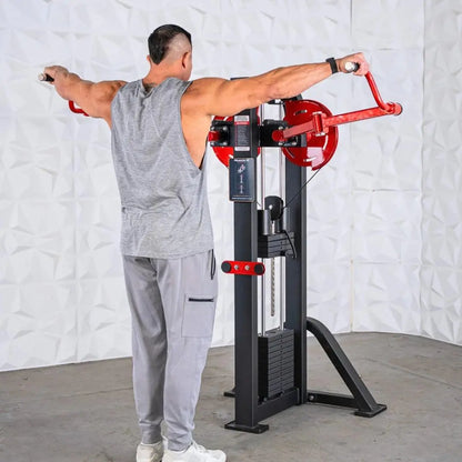 Man performing a standing lateral raise on a selectorized machine with red handles, black frame, and weight stack, against a white brick background.