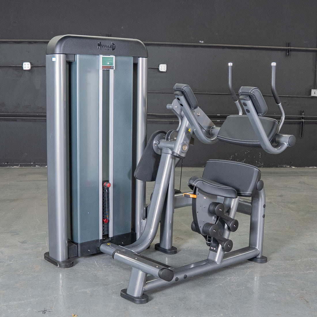 Muscled weight machine with adjustable seat, ideal for gym workouts.