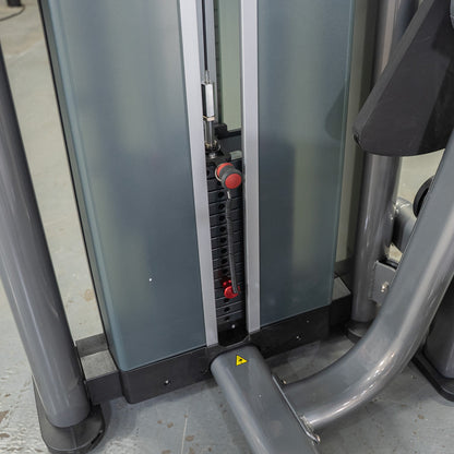 Gym machine weight stack with red selector pin.