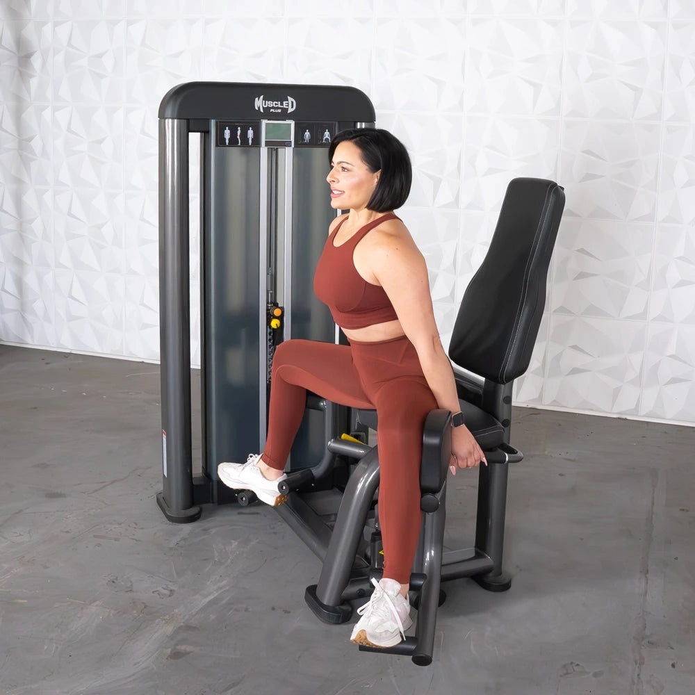 Woman seated on Muscle D Elite Plus Outer Thigh Machine.