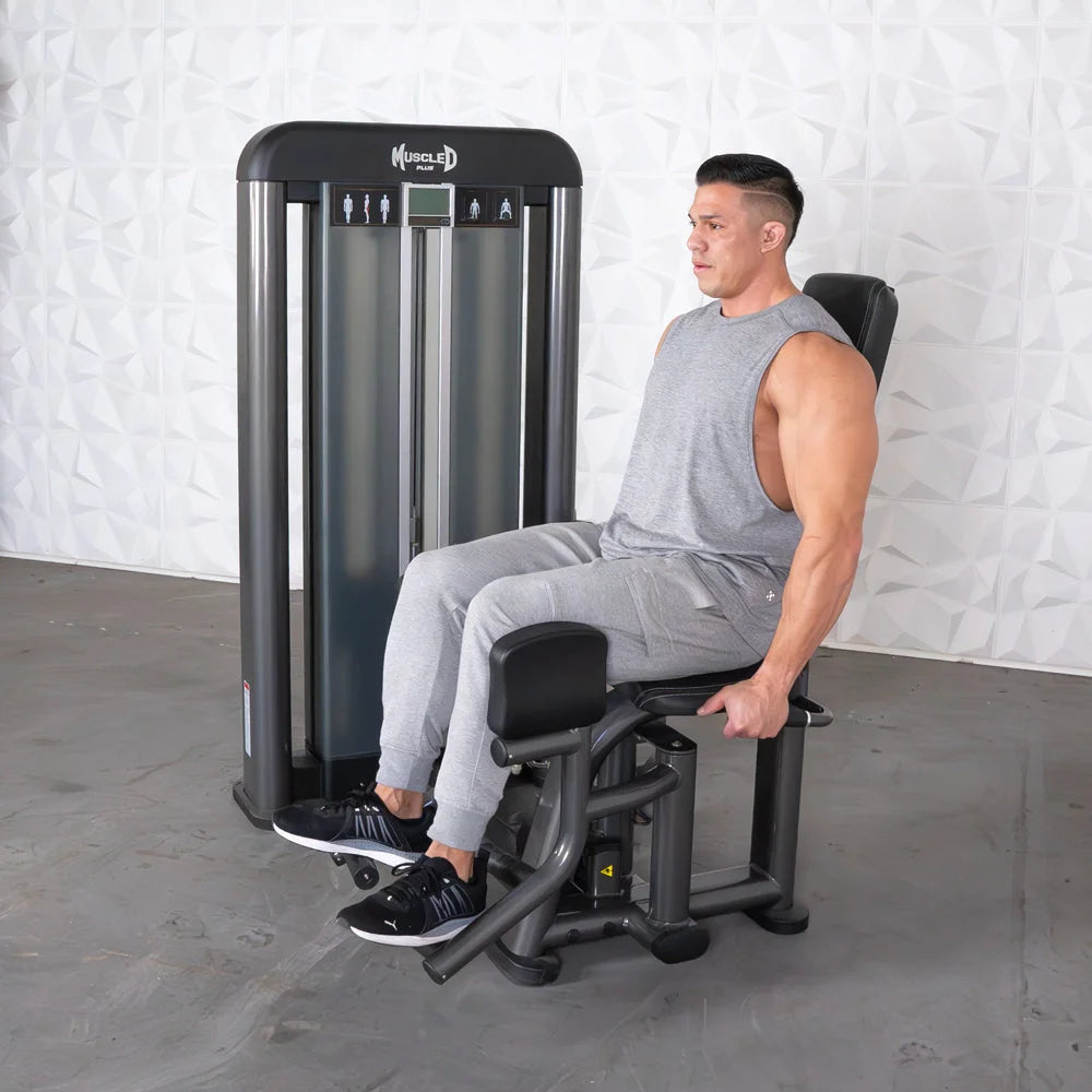 Man seated on Muscle D Elite Plus Outer Thigh Machine in gym