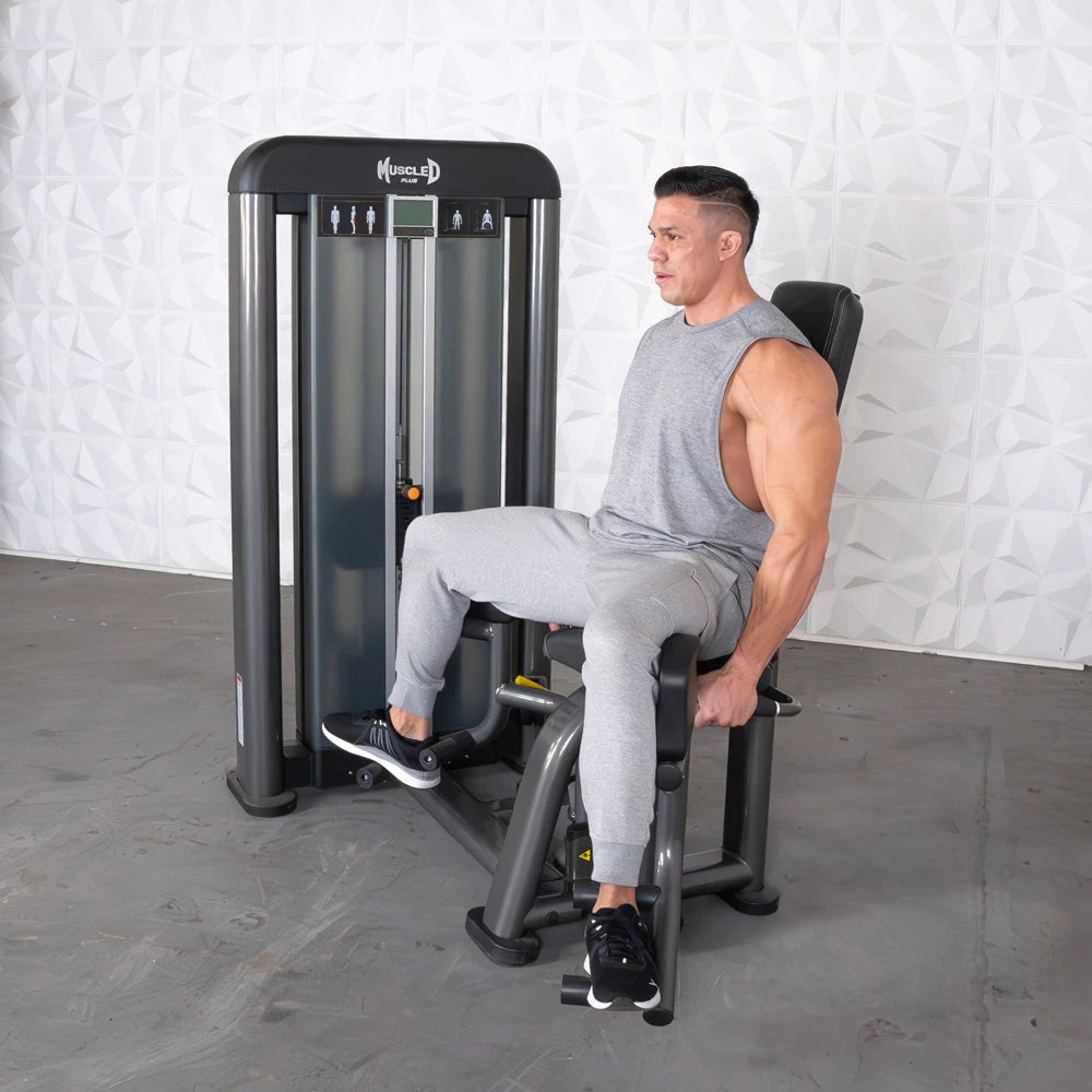 Man using Muscle D Elite Plus outer thigh machine at the gym.