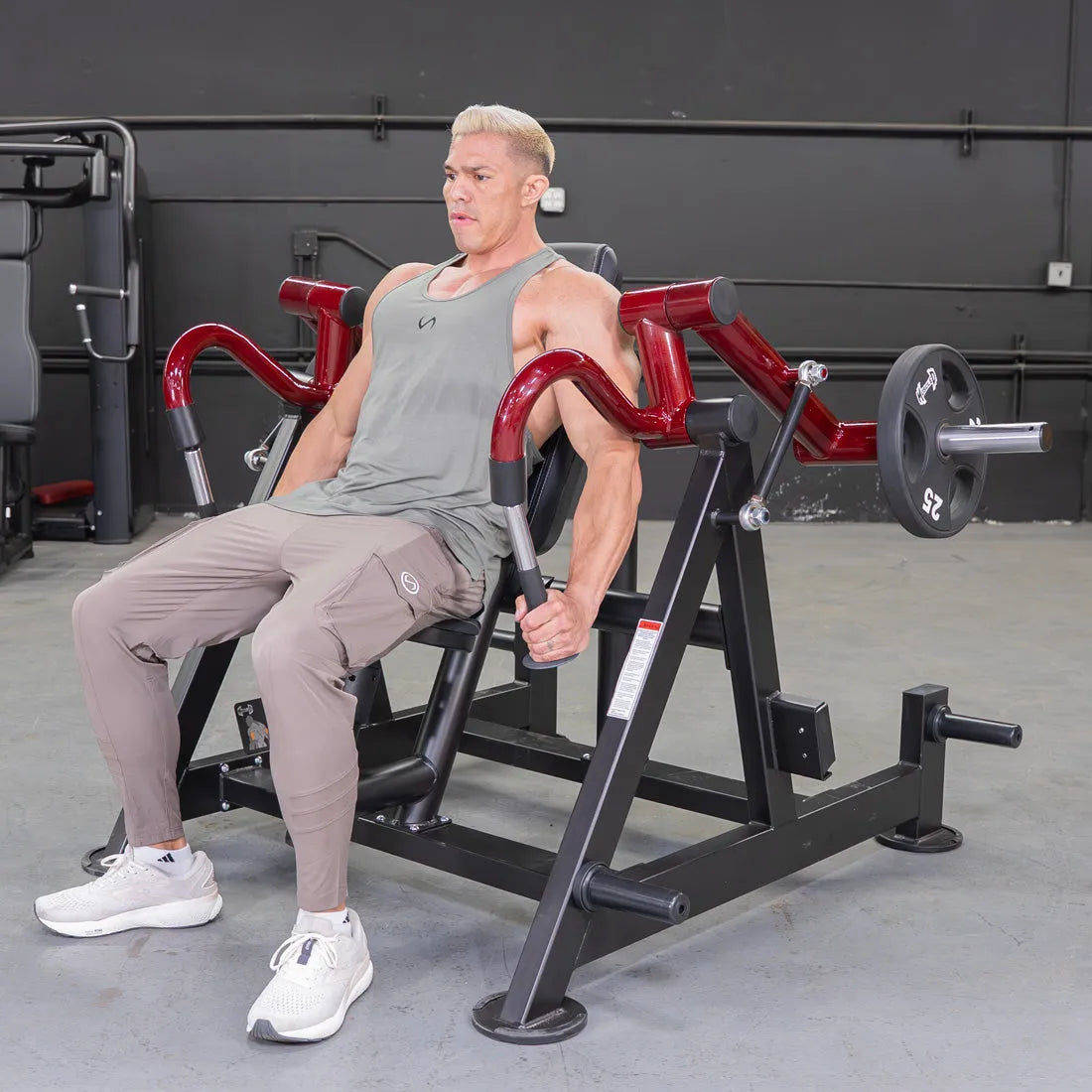 Man using a hammer-grip triceps machine on a gym bench.