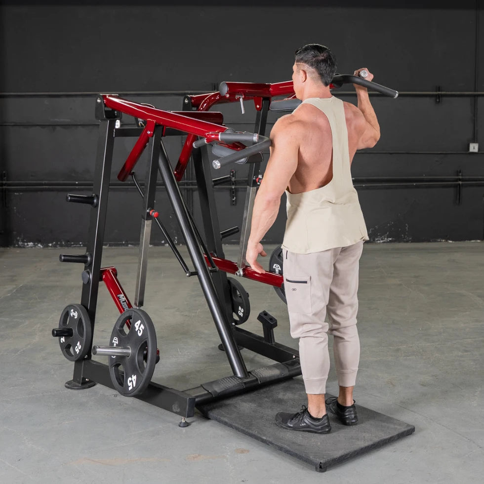 Man using a red power-leverage Viking press/calf machine in a gym.