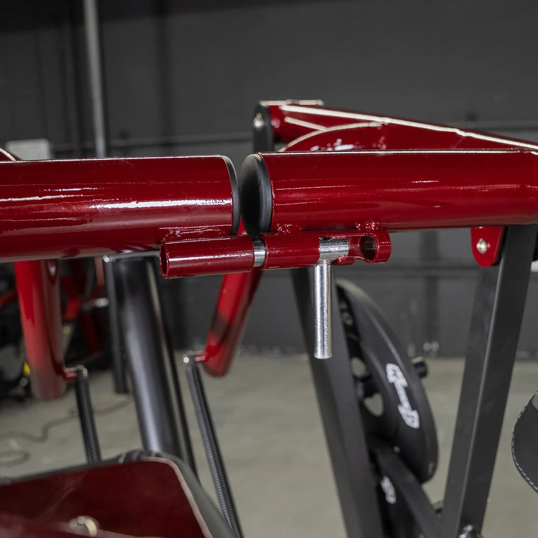 Close-up of a red power leverage Viking press calf machine component.
