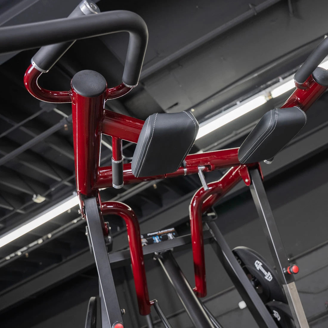 Red Viking Press Calf Machine with padded leg supports and metal frame.