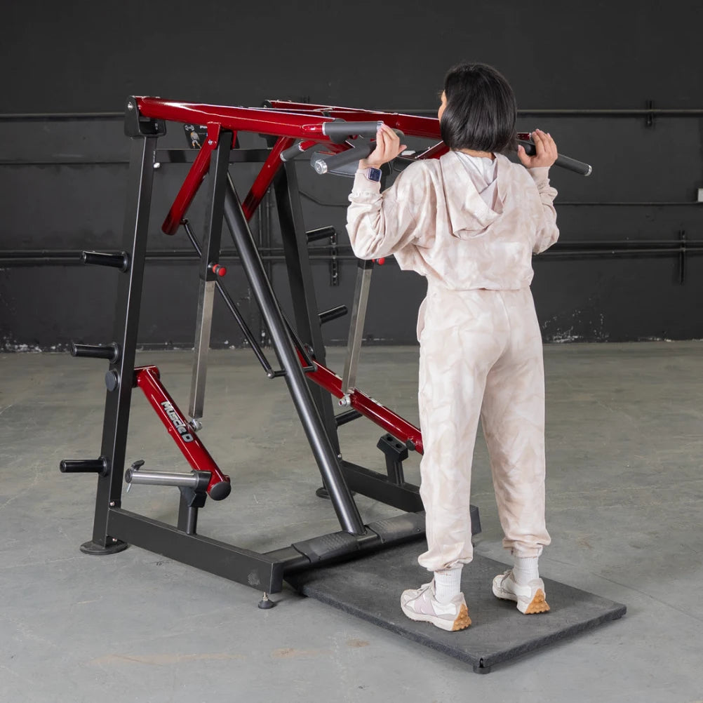 Person in light gym outfit using a red Power Leverage Viking Press Calf Machine.