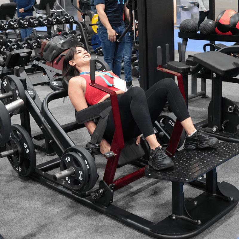 Woman using a hip thrust machine at the gym.