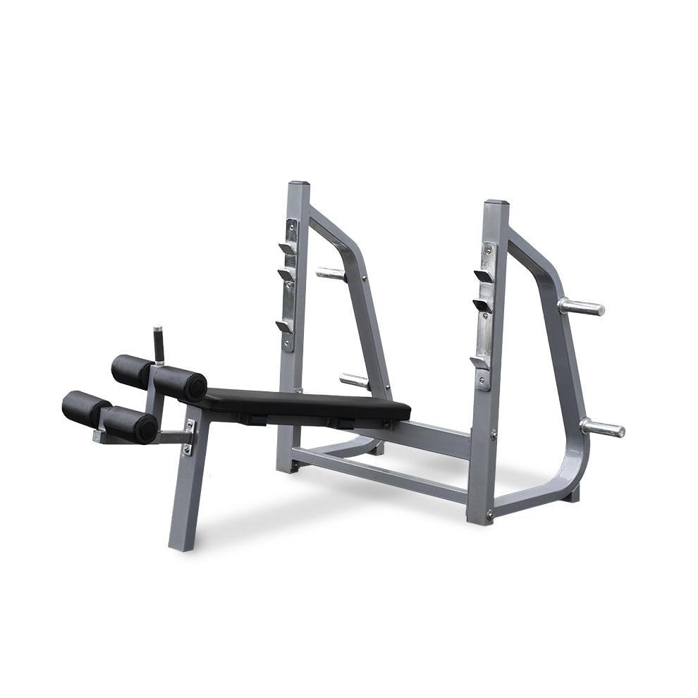Olympic decline bench press station with leg extension attachments.