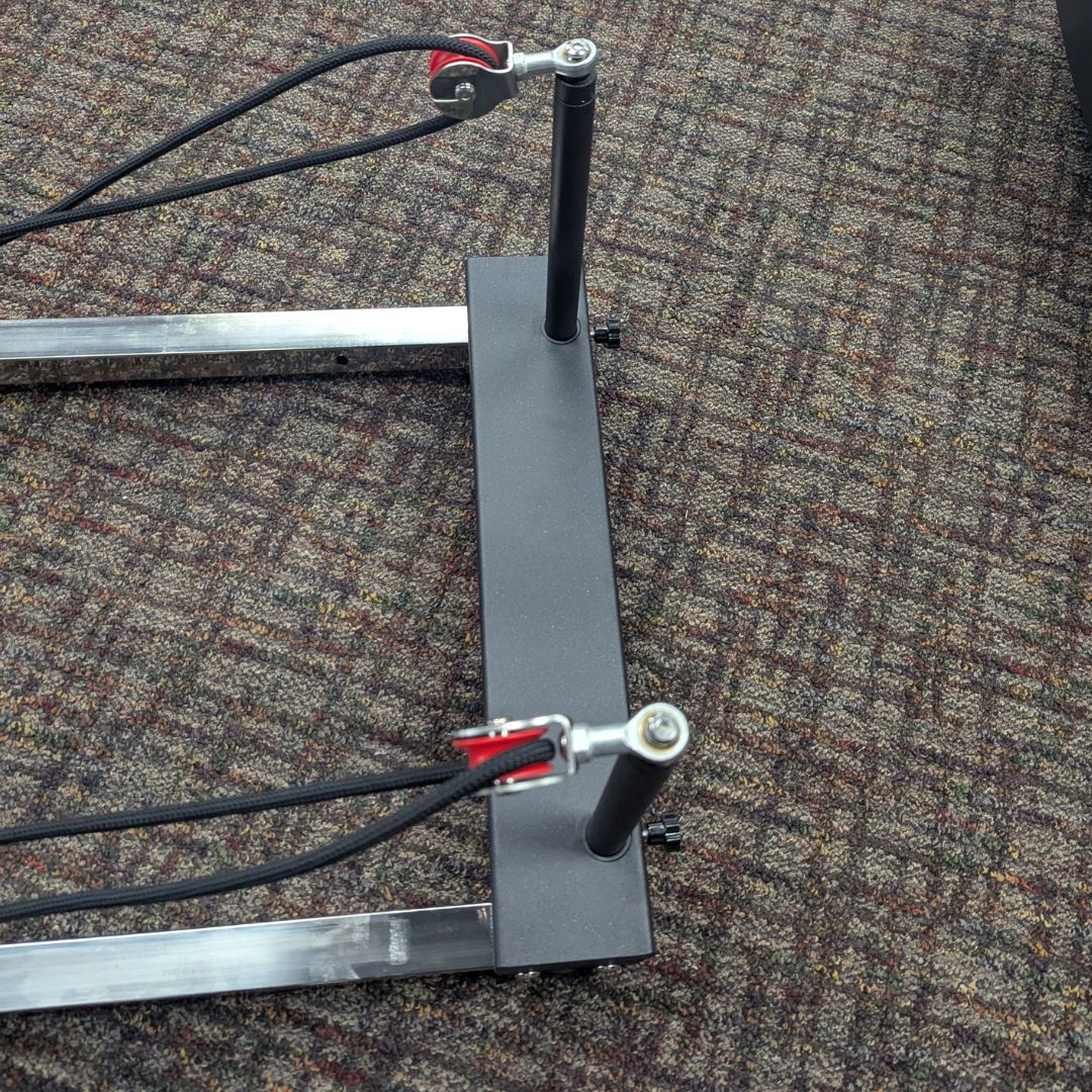 PILATESTABLE stand base with two vertical posts and cable clamps.