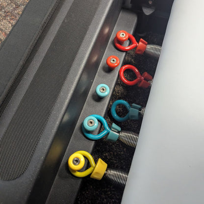 Close-up of colorful pins and springs on a Pilates reformer table.