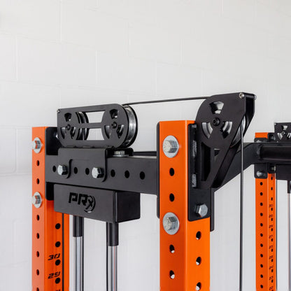 Orange and black weight machine with pulleys on a power rack.