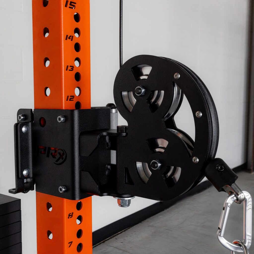 Industrial gym lift with orange post, pulley wheel and weight plate.