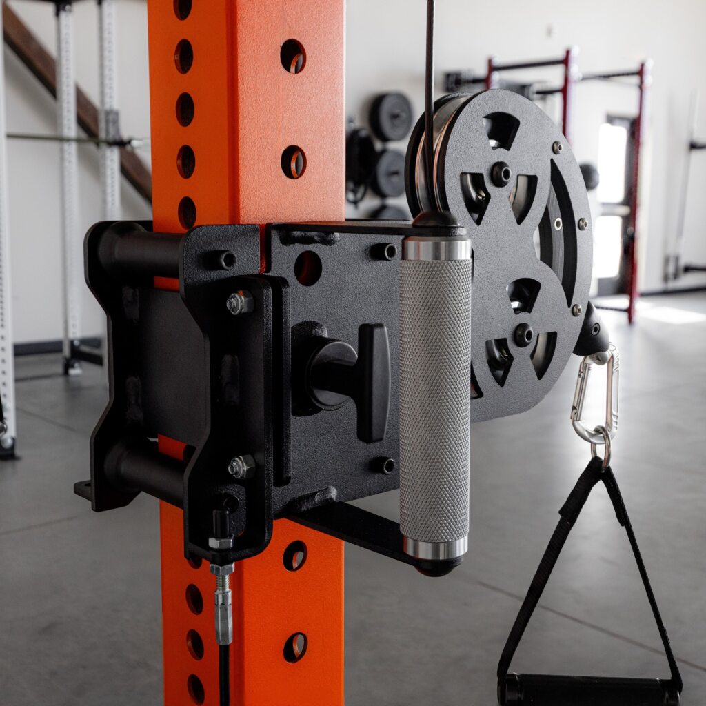 Gym weight machine with orange rack and weight plate.