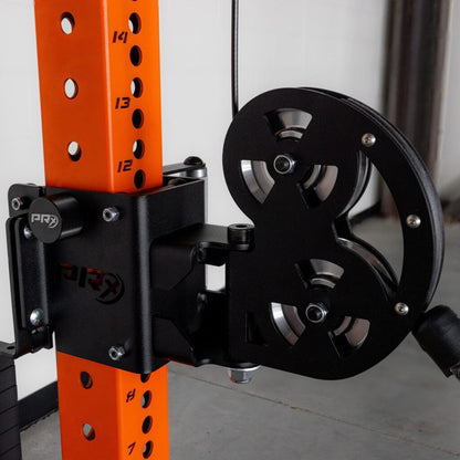 Gym power rack with orange vertical post and black pulley wheel.