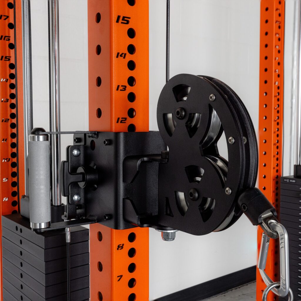 Weightlifting pulley machine attached to orange rack.