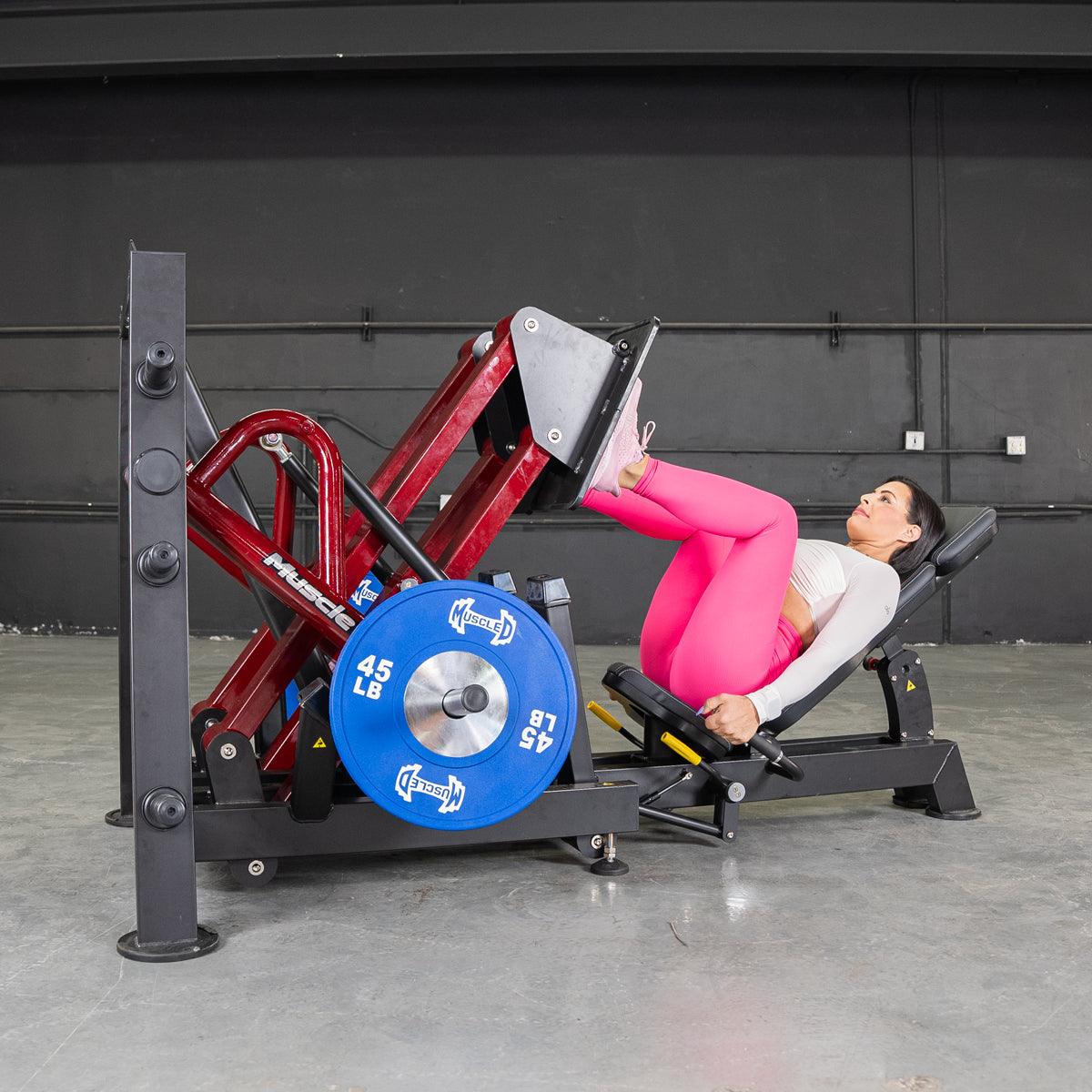 Woman in pink leggings on a 45-degree iso-lateral leg press.