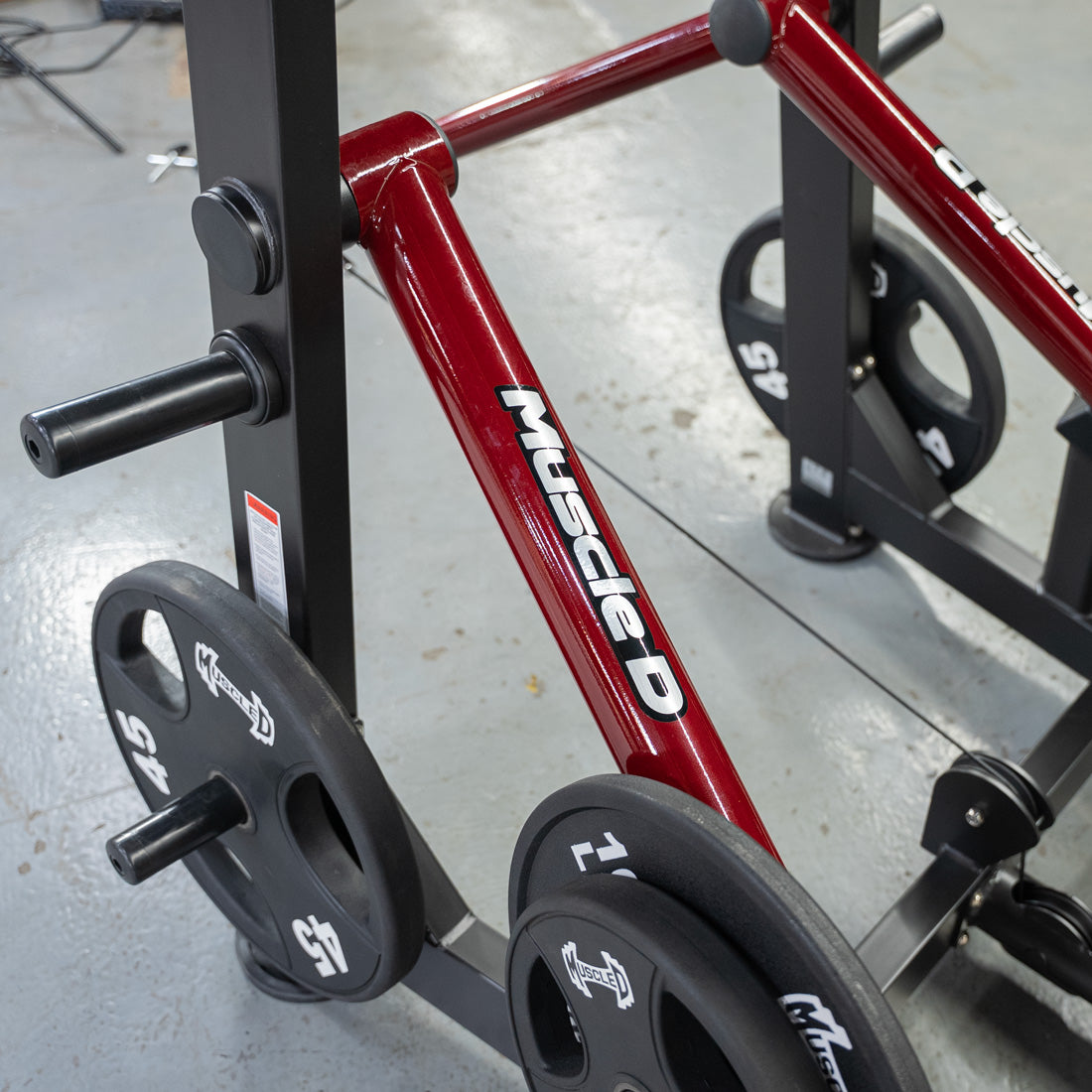 Red PowerLeverage V2 Abductor/Adductor machine on gym rack