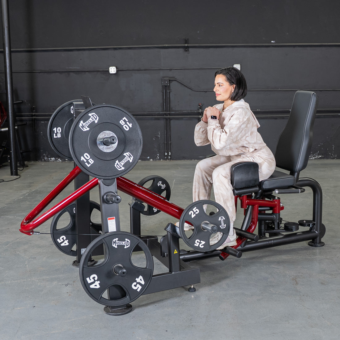 Woman using Power Leverage V2 Abductor-Adductor machine in a gym.