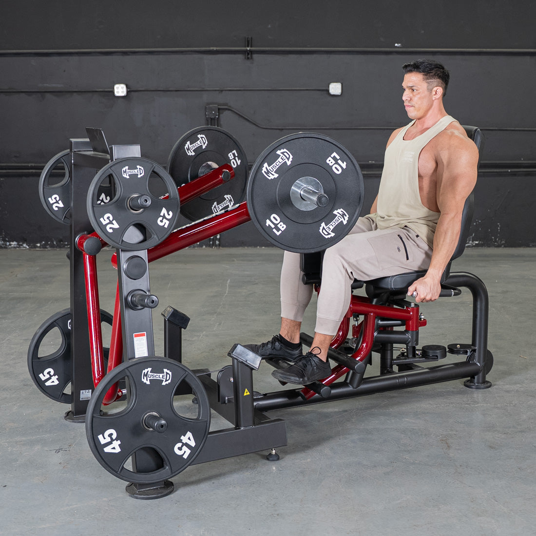 Man seated on a Power Leverage V2 leg abductor/adductor machine.