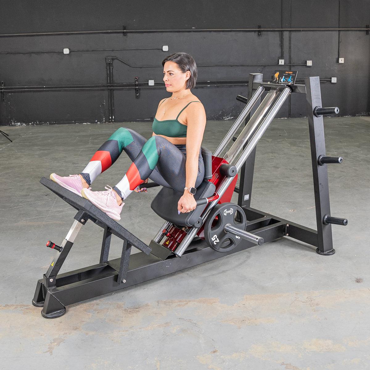 Woman on a hack-squat lever machine in a gym.