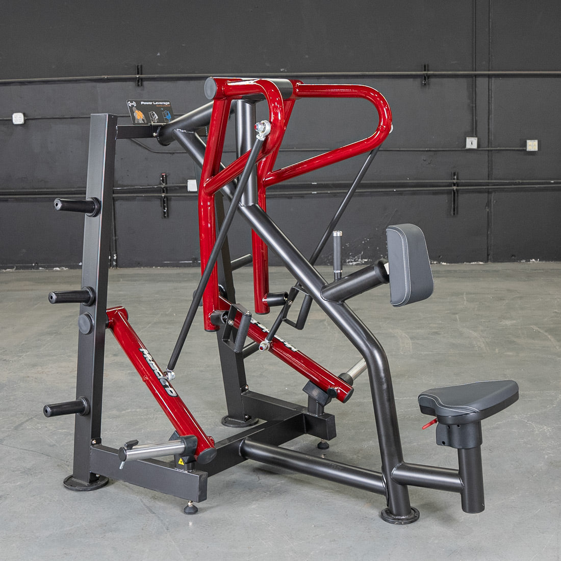 Red and black gym machine with ergonomic seat for strength training.