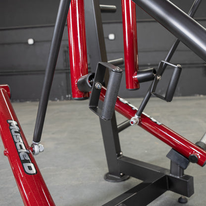 Muscle D Fitness equipment with red and black frame, featuring ergonomic handles.