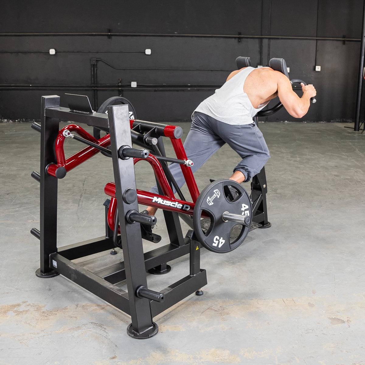 Man using Power-Leverage Iso-Lateral Sprint Trainer at gym with weight plates.
