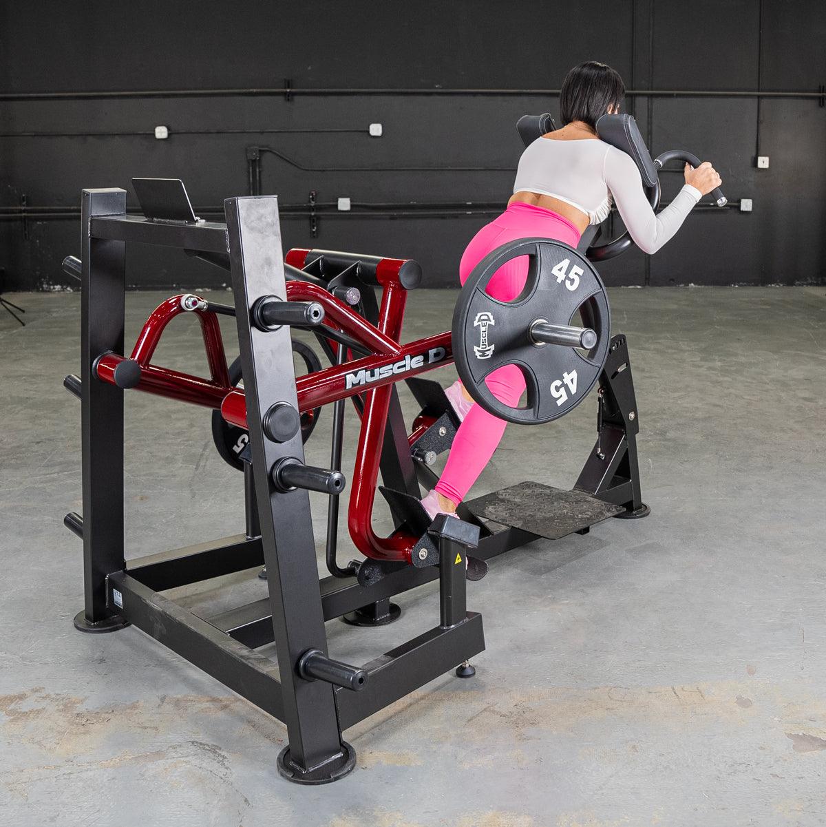 Person using Power-Leverage iso-lateral sprint trainer with 45 lb plate